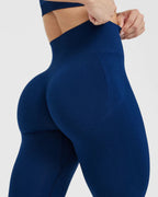 Navy blue leggings worn by a person on a light gray background