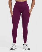 Person wearing purple leggings on a white background